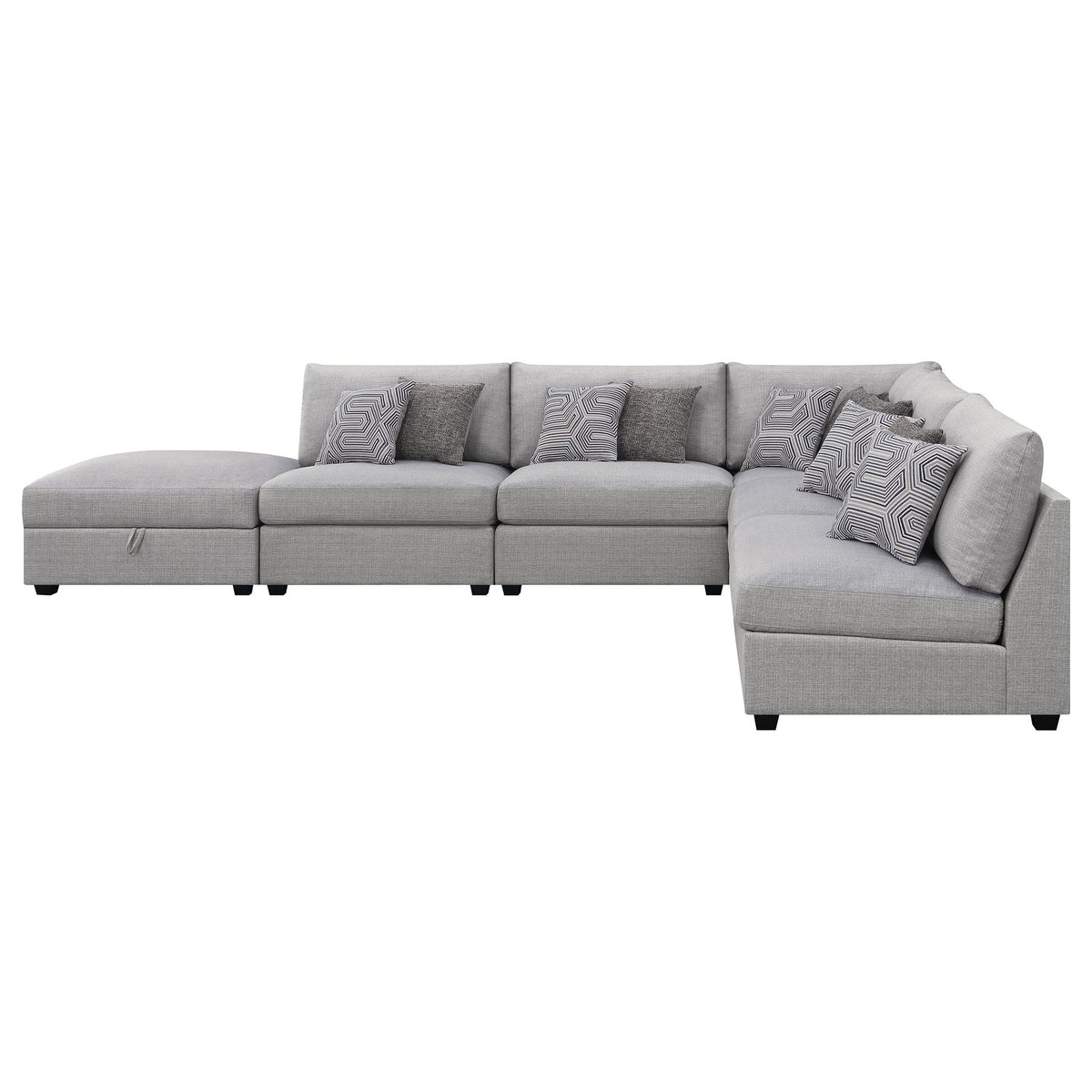 Grey modular sectional sofa with multiple seat sections and patterned accent pillows