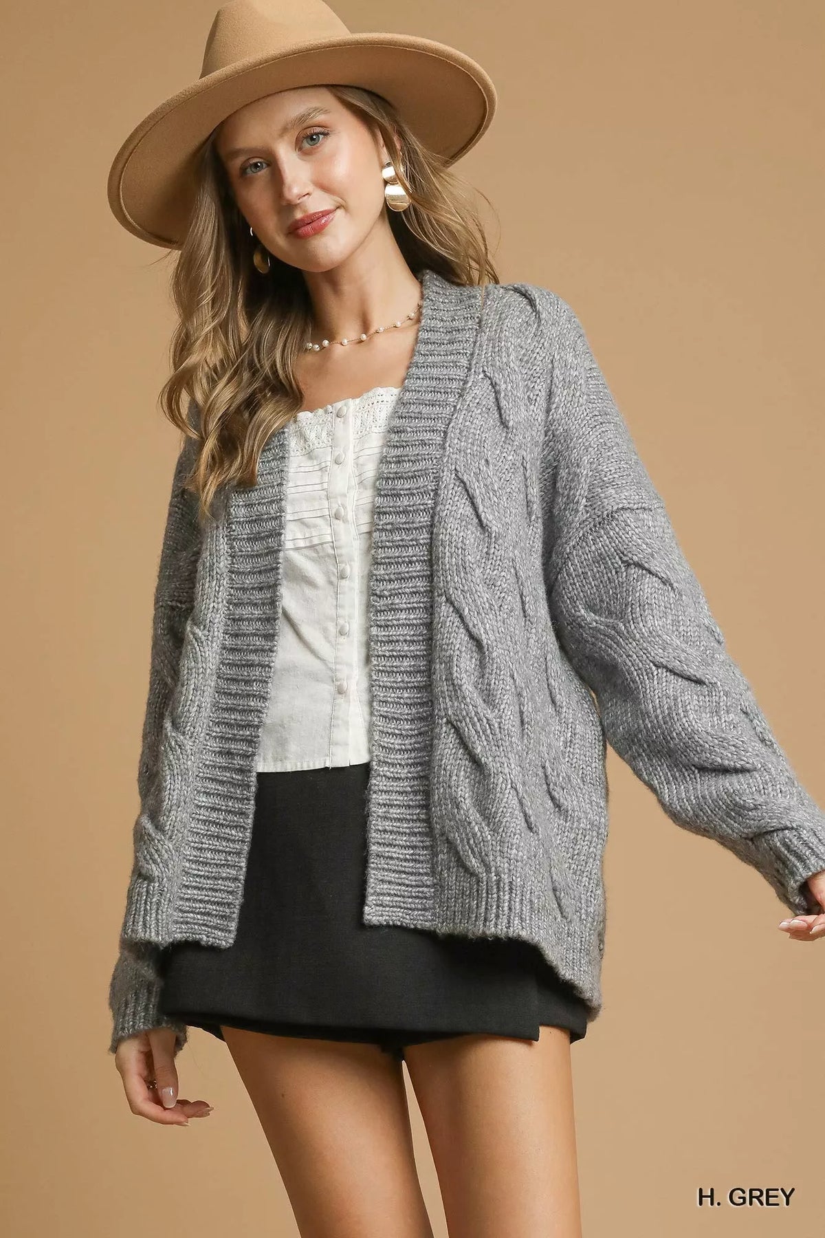 Grey chunky cable-knit open-front cardigan with long sleeves, textured cable pattern