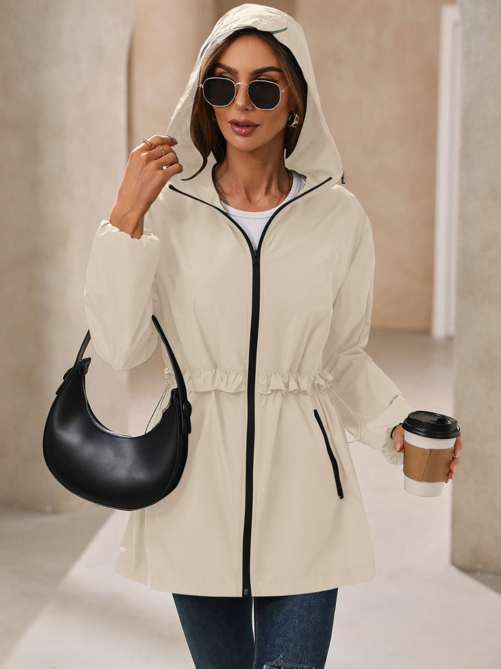Women’s hooded windbreaker jacket, light tan with black zipper and side zip pockets
