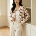 Cream striped cardigan with button front, long sleeves, contrasting red and dark stripe trim