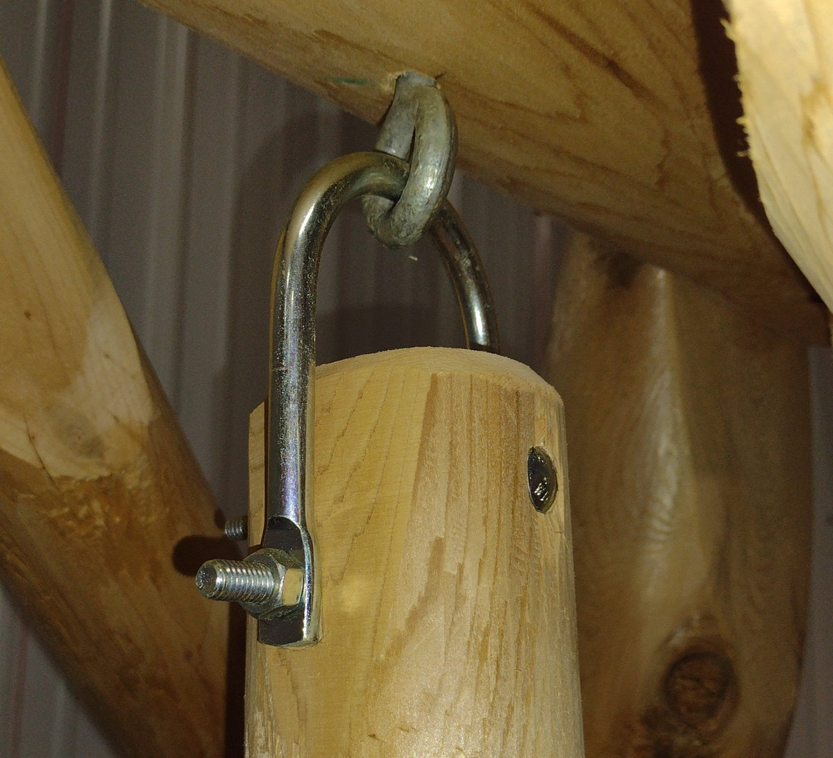 Wooden porch swing chain and padlock-style latch on wood support