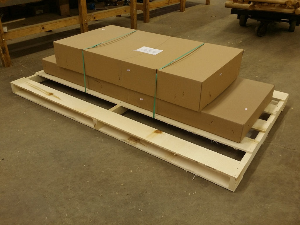 Wood porch swing parts on shipping pallet with wrapped packages