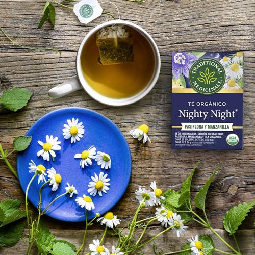 Traditional Medicinals Nighty Night tea with passionflower in cup and blue plate, pack included