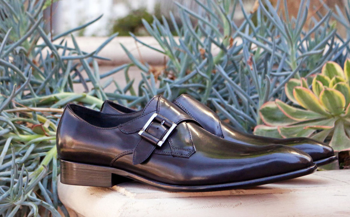 Dark brown monk strap leather dress shoe with buckle strap detail