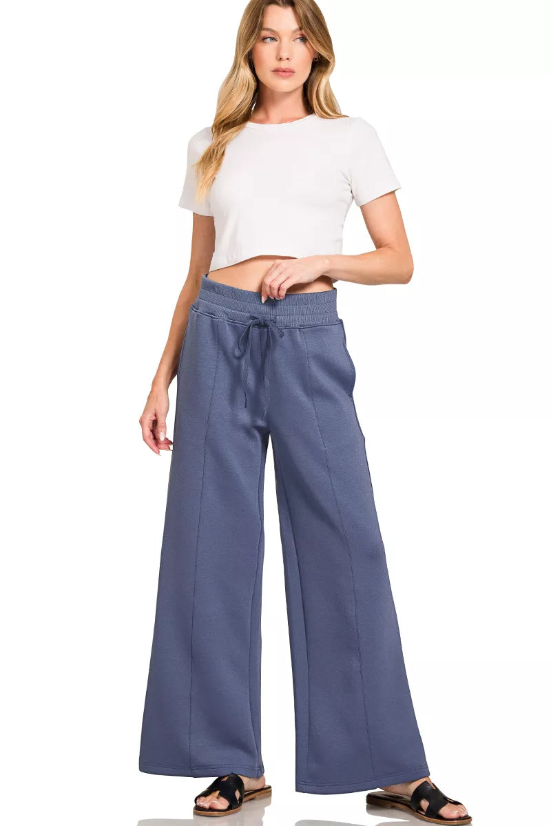 Blue indigo wide-leg pants with drawstring waist and center seam