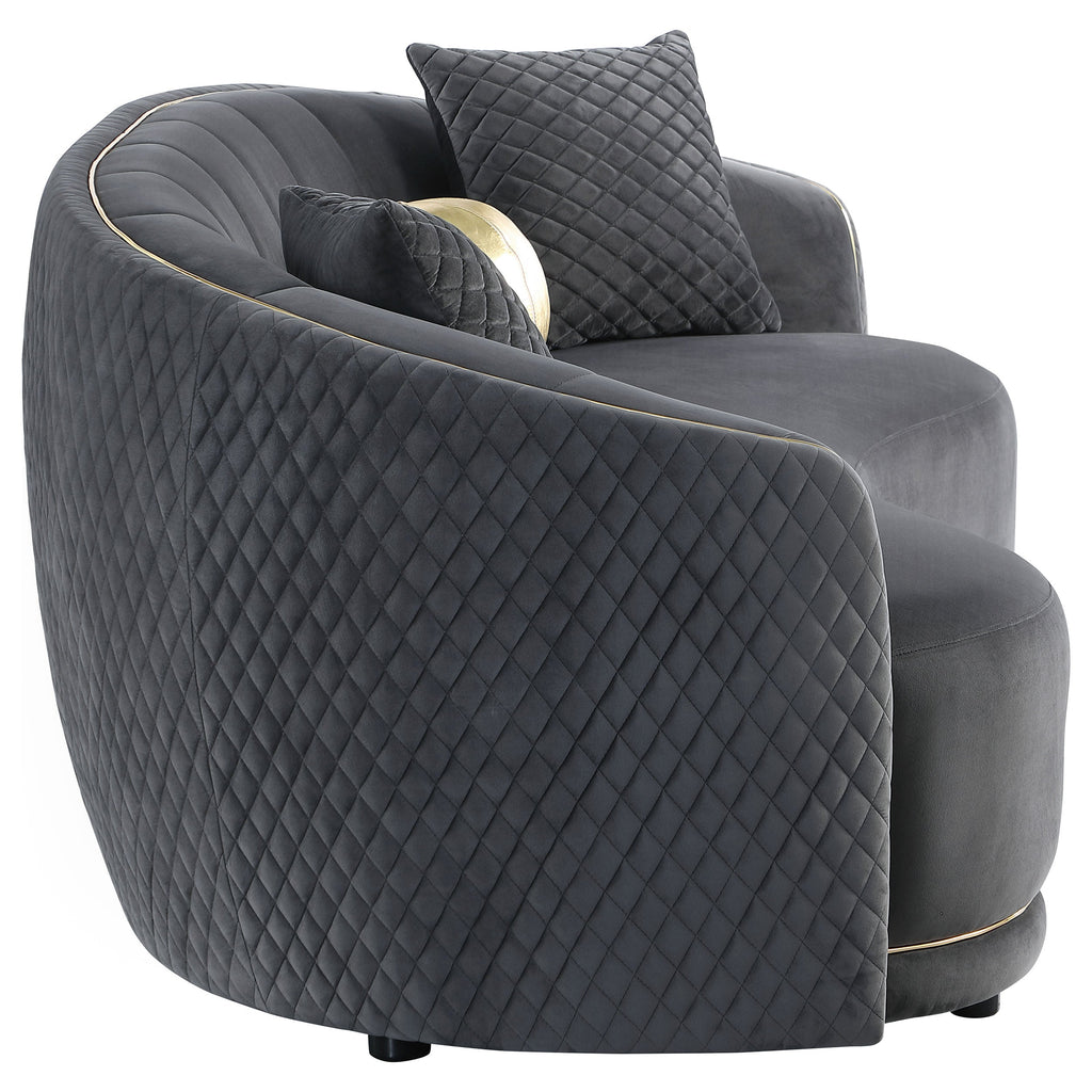 Dark grey velvet armchair-style sofa with quilted upholstery and gold edge piping