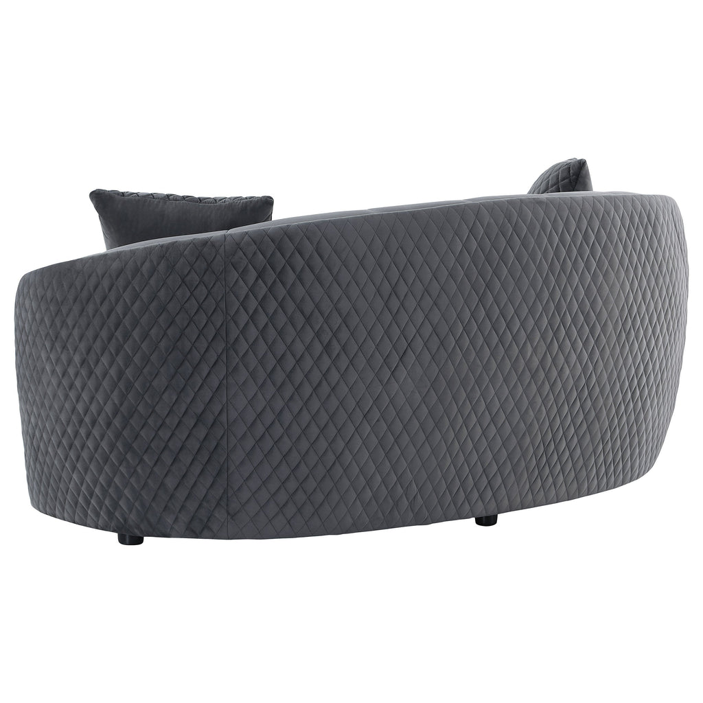 Dark grey velvet curved sofa with quilted texture, two back cushions, gold trim piping