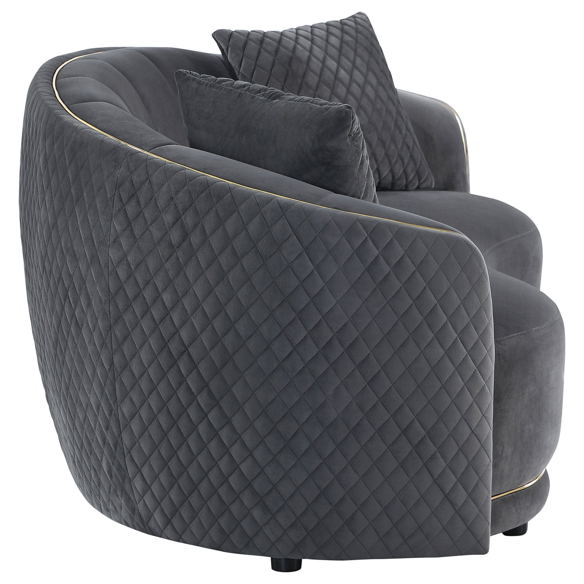 Dark grey velvet lounge sofa with quilted sides, plush seat, and gold edge piping