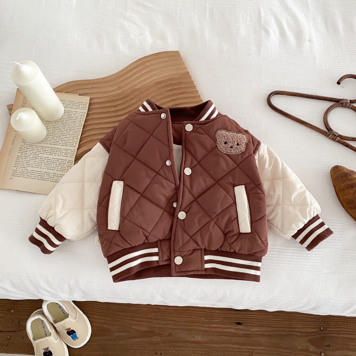 Kids reddish-brown quilted baseball jacket with snap buttons and striped ribbed sleeves