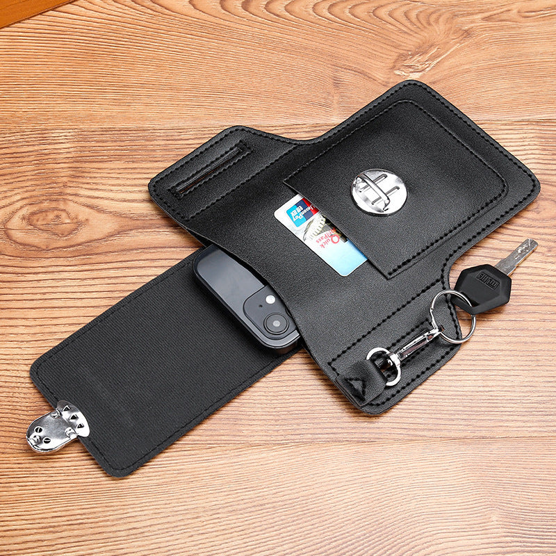 Black waist bag pouch with open pockets, buckle tab, and key ring on strap