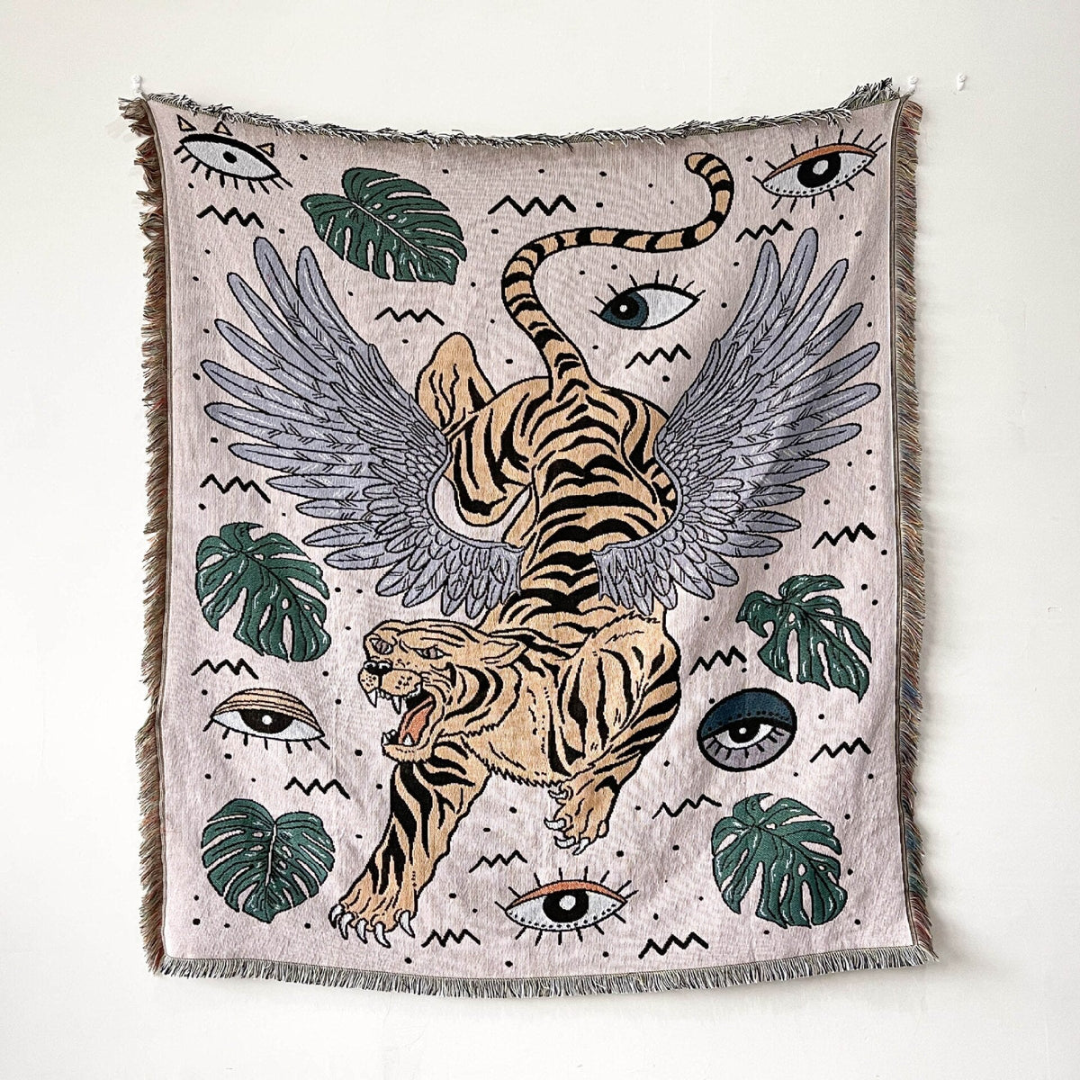Light towel blanket with winged tiger and many eye icons, fringed edges