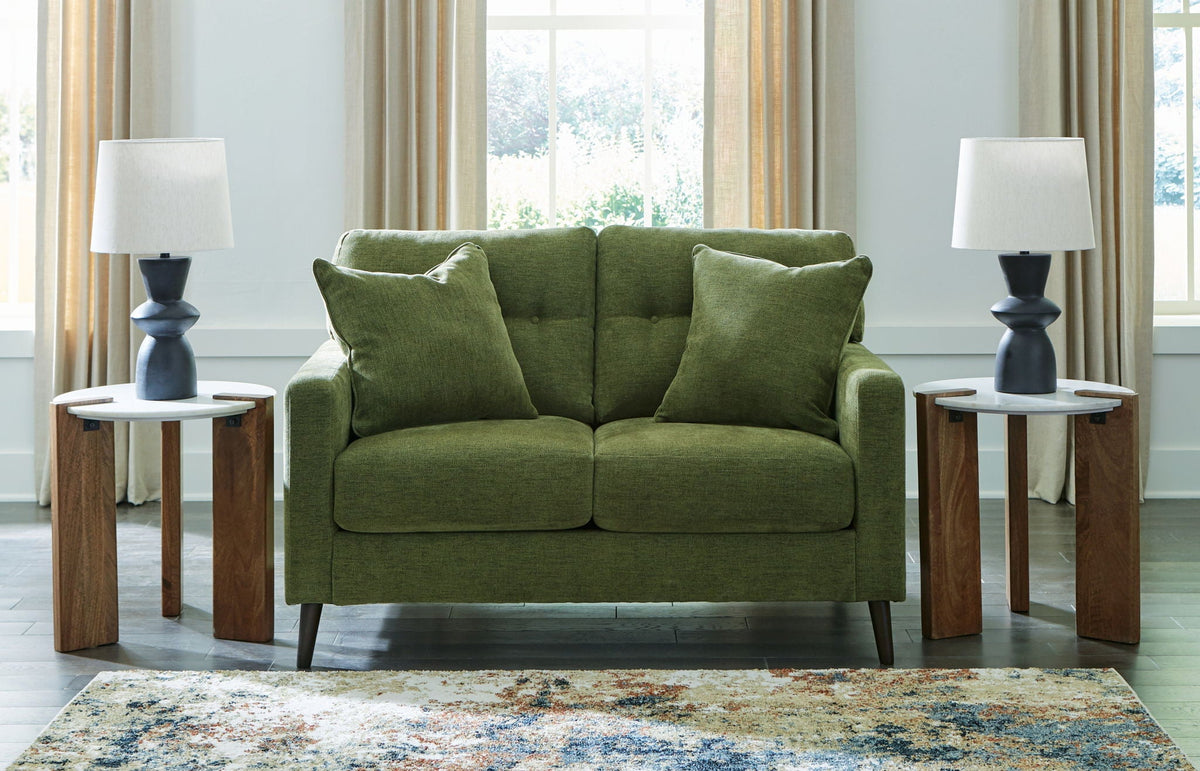 Green fabric sofa with plush back and seat cushions and tapered legs