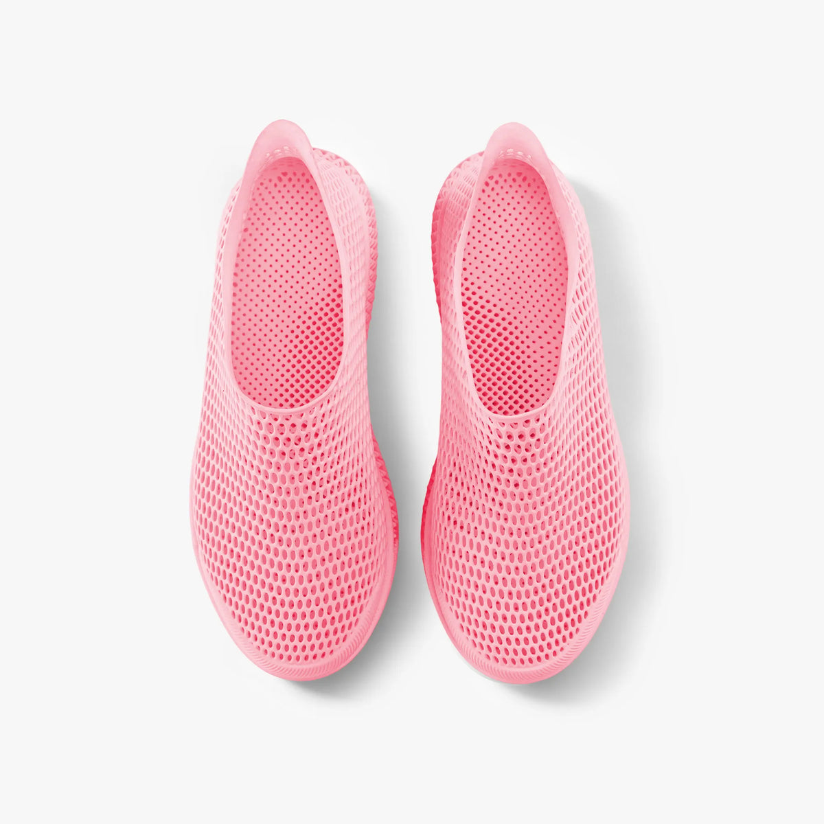 Pair of pink 3D-printed slip-on sneakers, front view with mesh-like texture