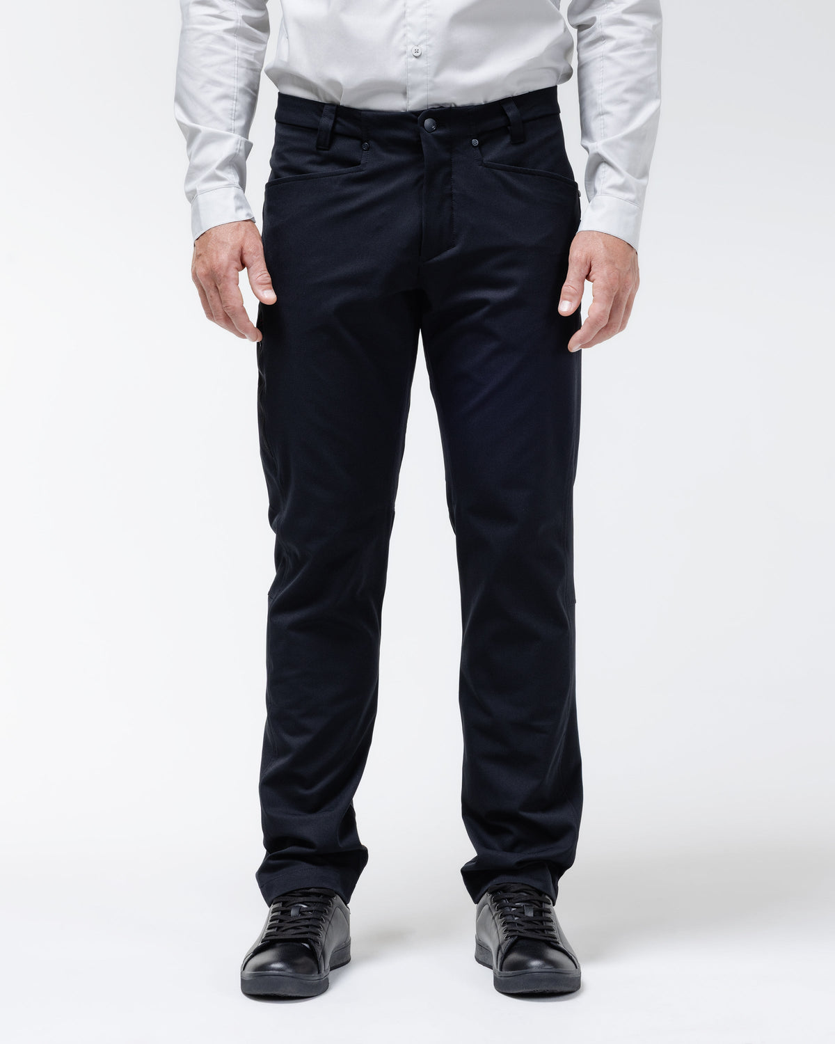 Men's black chino pants with belt loops and front button closure.