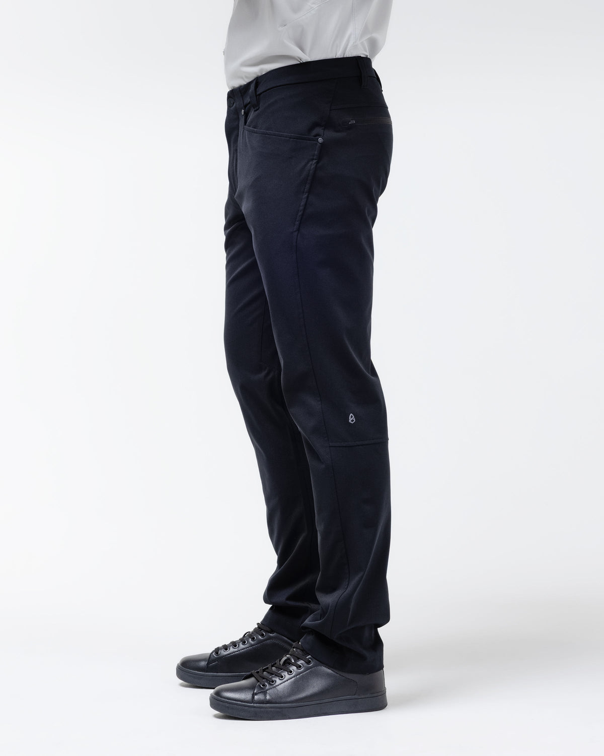 Men's black chino pants side view with cuffed hem and angled side pockets.