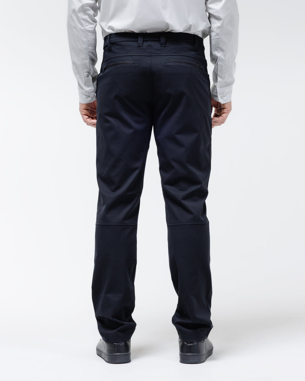 Men's black chino pants shown from behind with back yoke and belt loops.