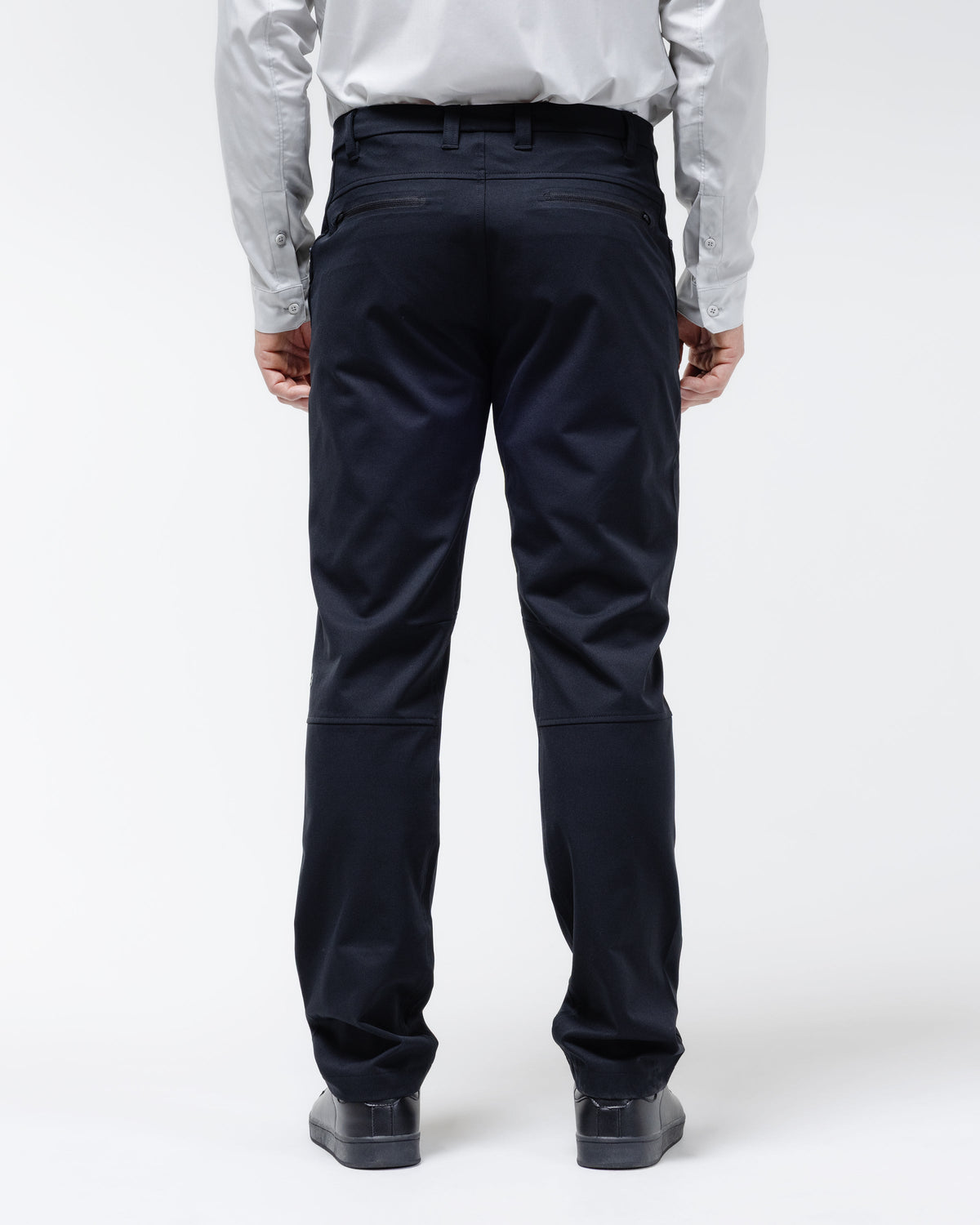 Men's black chino pants shown from behind with back yoke and belt loops.