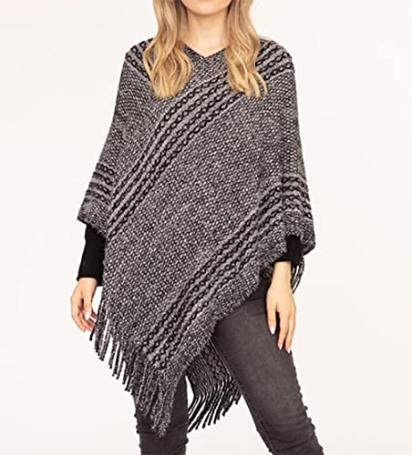 Women's dark gray striped V-neck knitted poncho with fringe tassels, worn over leggings