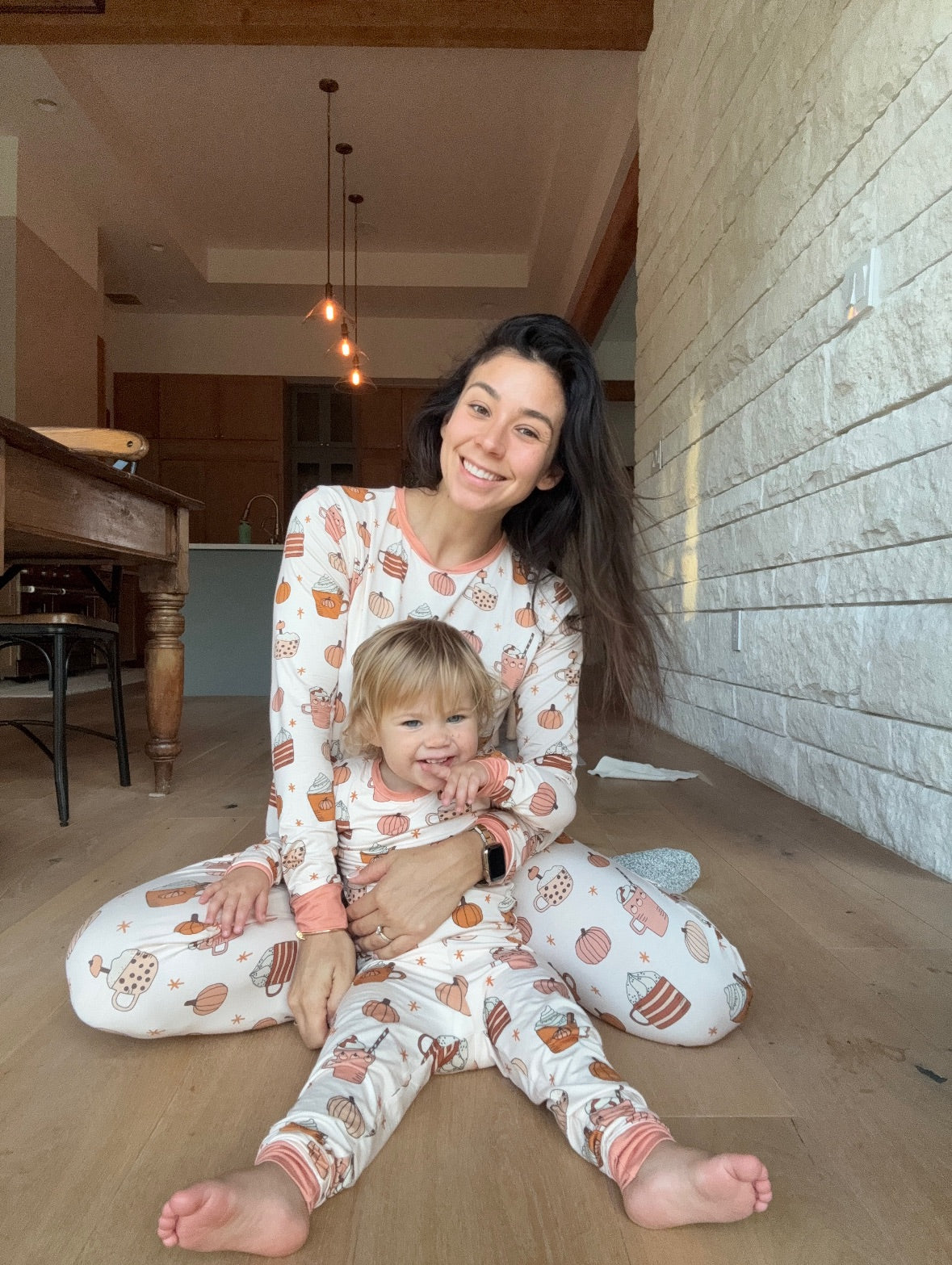 Kids long-sleeve pajama set with pumpkin, coffee, and cookie pattern; orange cuffs