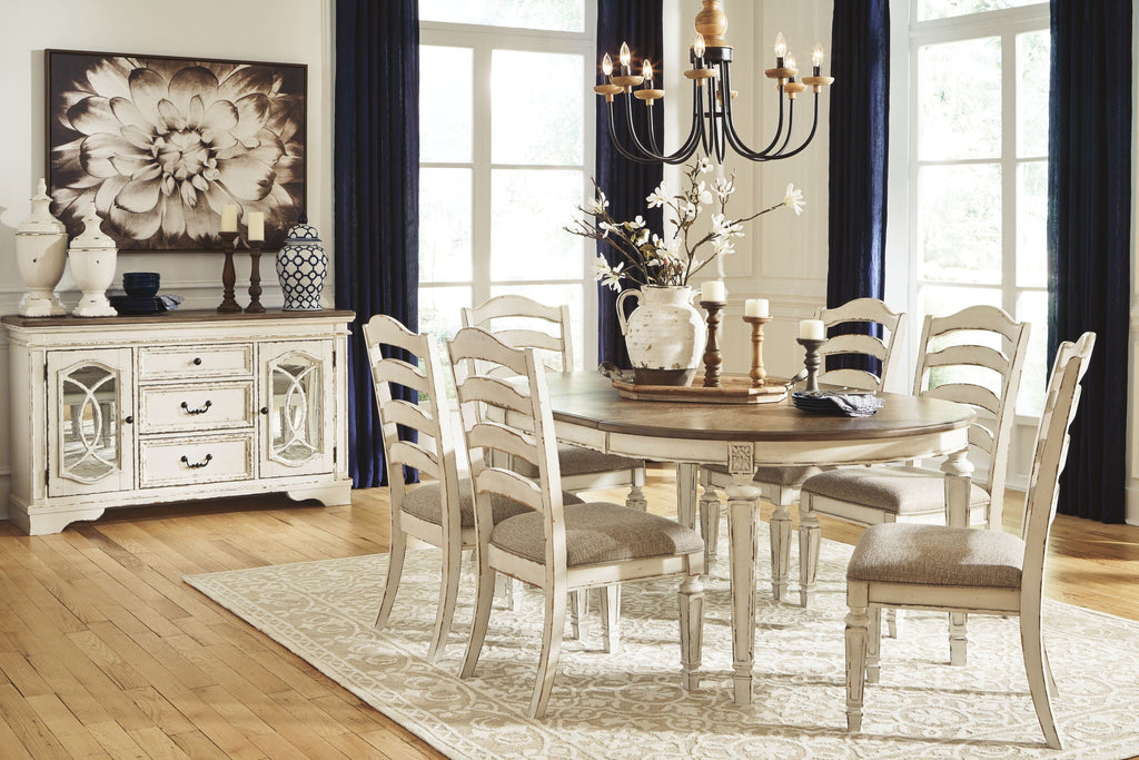 White oval dining table with ladderback chairs and taupe cushioned seats