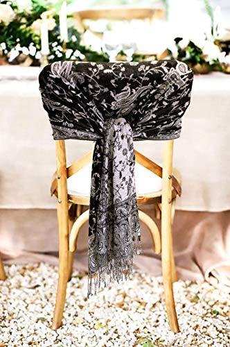 Black and white paisley jacquard pashmina wrap with fringed ends, tied around chair.