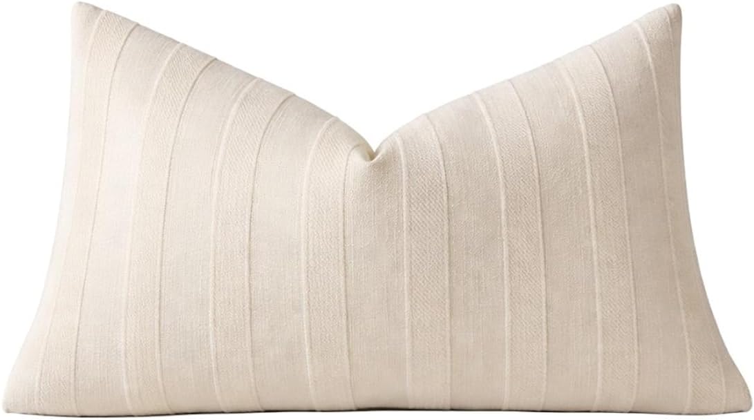 Light beige striped throw pillow cover close-up, smooth knife-edge seam at top.
