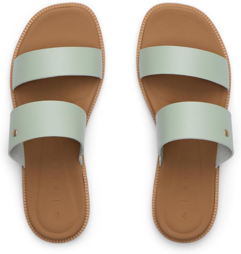 Pair of women's slide sandals with mint wide straps and tan footbed