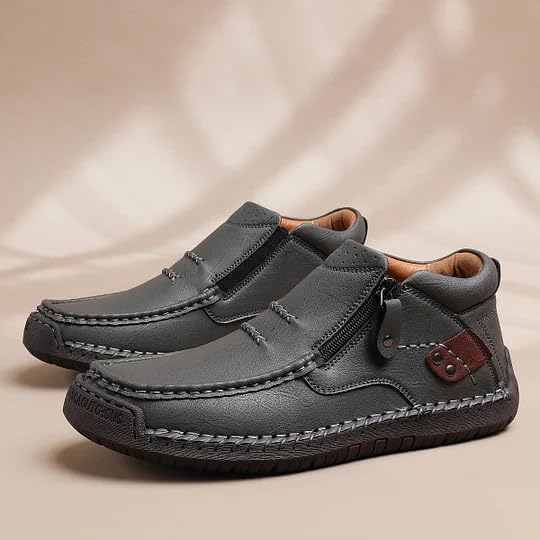 Grey leather driving boot with two side zippers and decorative stitched rubber sole