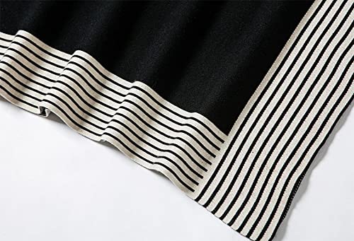 Striped knit cuff band on black poncho sweater with narrow light-and-dark stripes