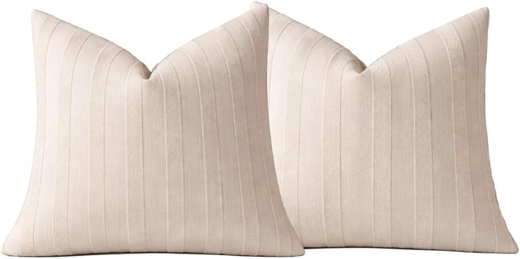 Two light beige striped throw pillow covers, front views with V-shaped top seams.