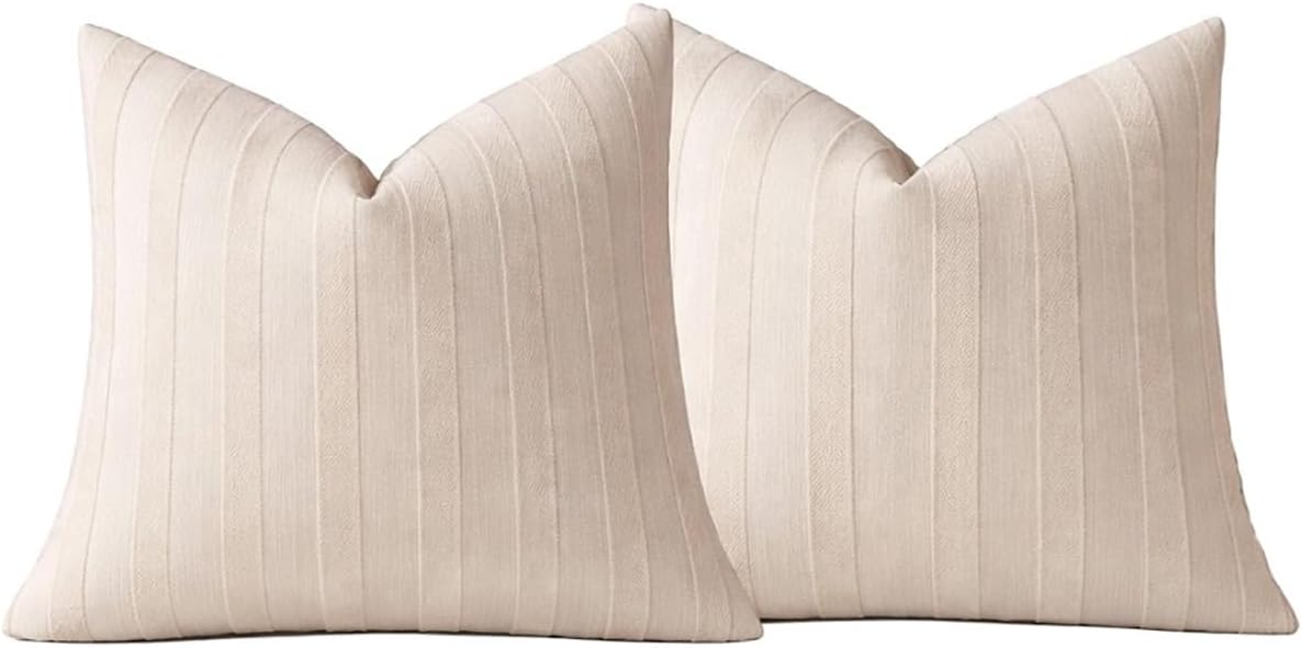 Two light beige striped throw pillow covers, front views with V-shaped top seams.