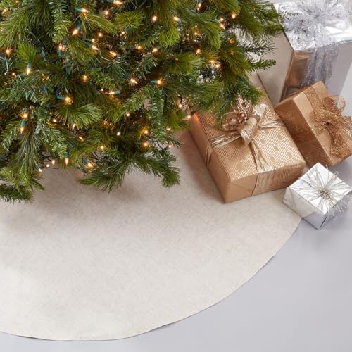 Natural round Christmas tree skirt beneath Christmas tree lights and gift boxes