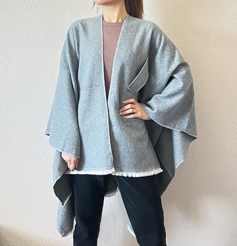 Light blue open-front fringe poncho shawl with V neckline and stepped hem