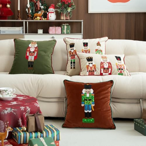 Set of nutcracker embroidered pillow covers on a sofa: brown, white, and green designs.