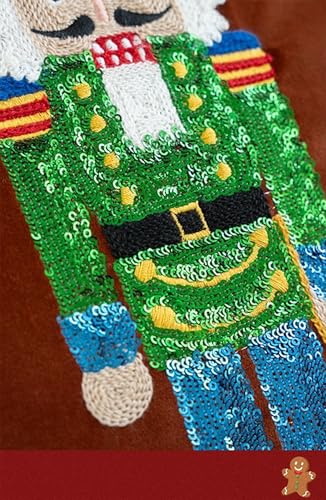 Close-up of embroidered sequin nutcracker on the brown velvet pillow cover, green and blue details.
