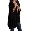 Black knitted poncho cape with pockets, open front and draped shawl collar.