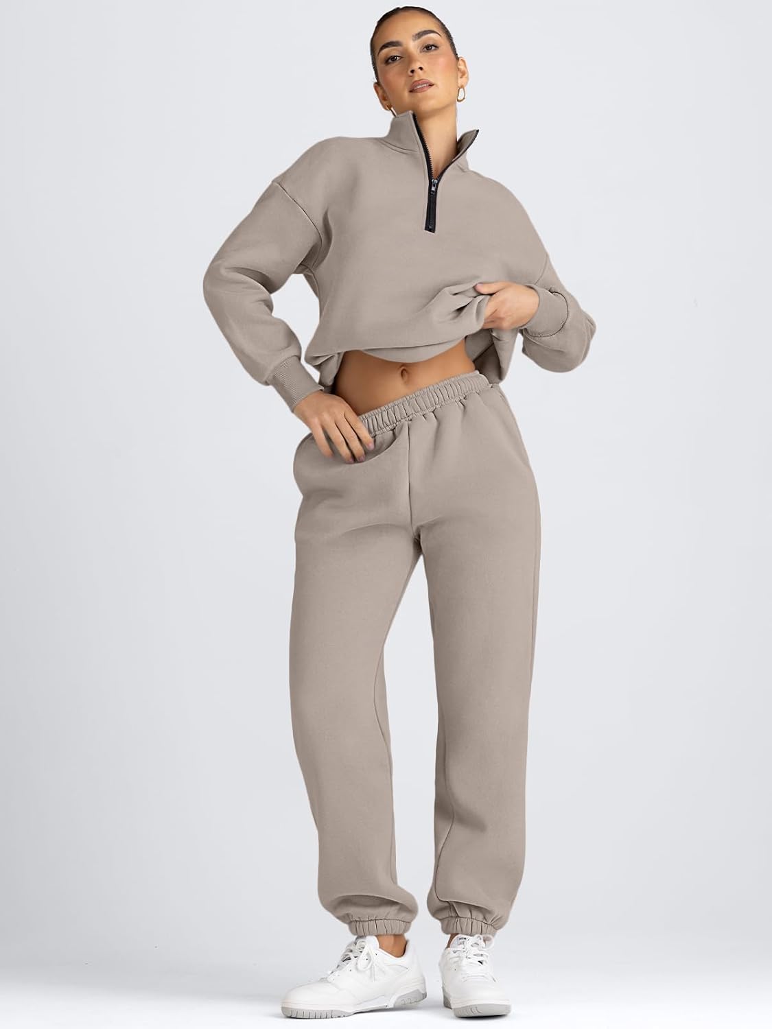 Women’s taupe half-zip pullover and jogger sweatpants lounge set, hands in pockets