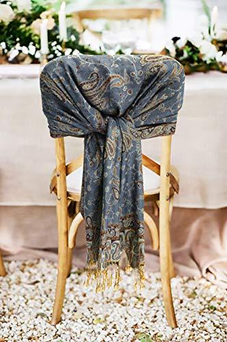 Dark blue paisley pashmina shawl with fringed edges, draped on a chair