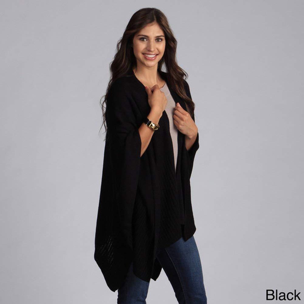 Black knitted poncho cape with pockets and draped shawl front worn over jeans.