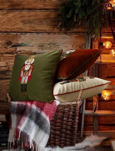 Green and brown nutcracker embroidered pillow covers on a couch with rustic holiday decor.