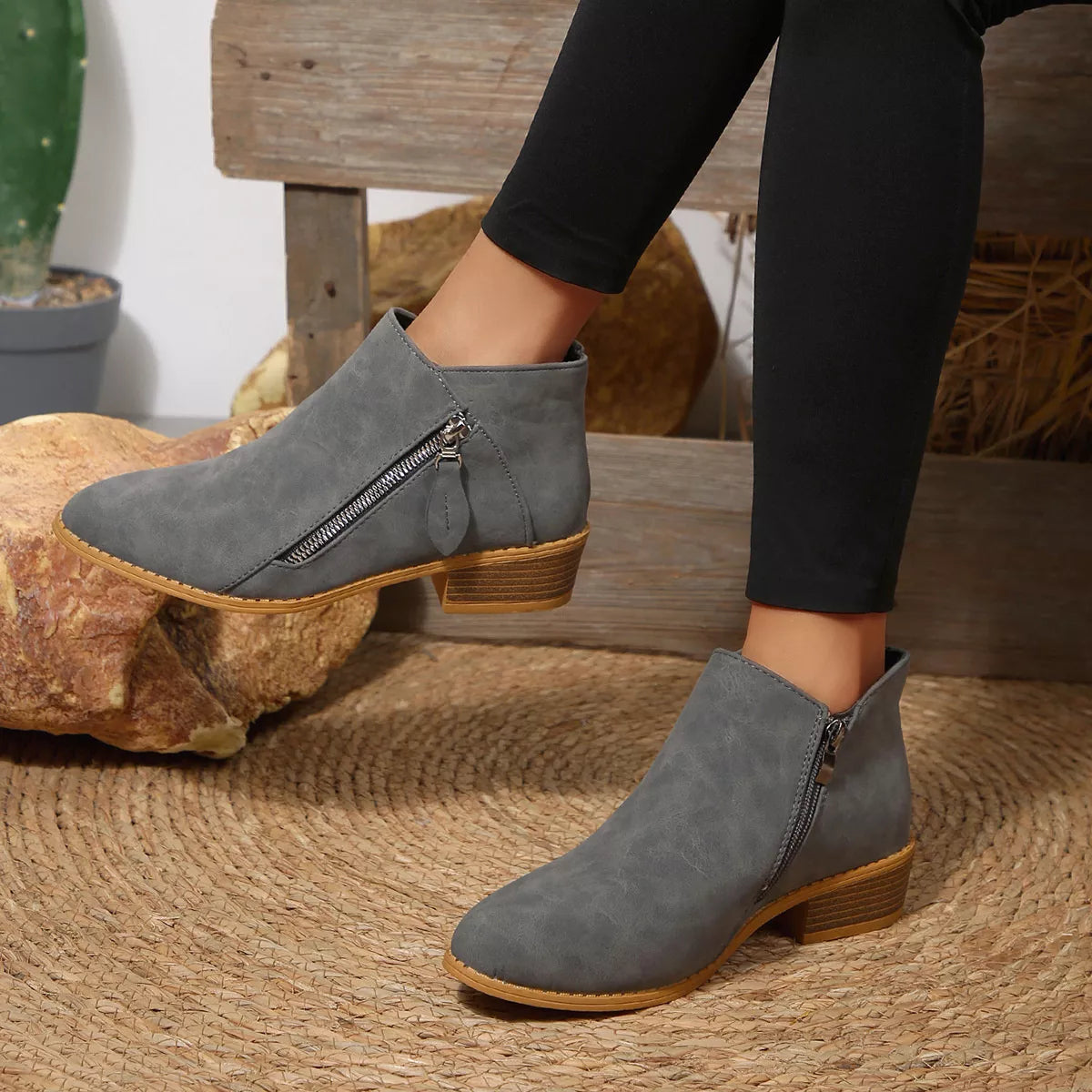 Dark gray block-heel ankle boots with side zipper and tan rubber sole