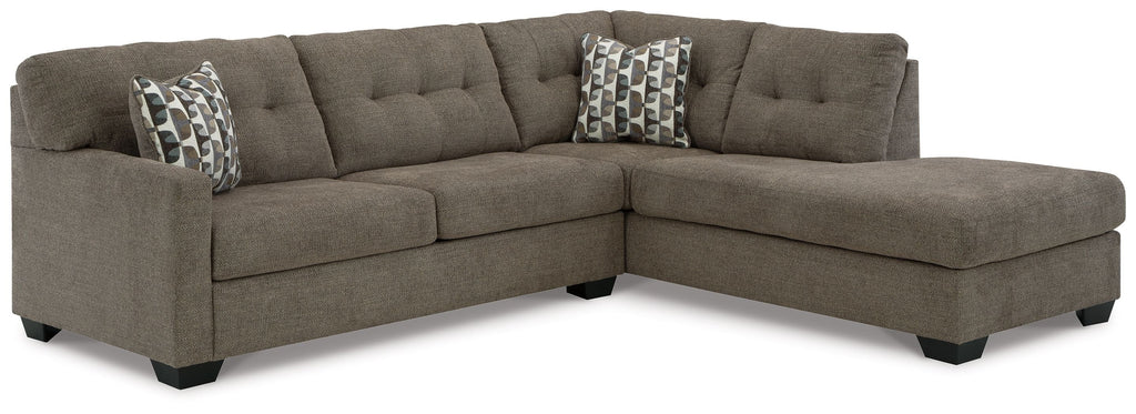 Dark gray sectional sofa with corner chaise and tufted seat cushions