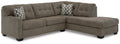 Dark gray sectional sofa with corner chaise and tufted seat cushions