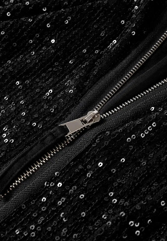 Black sequin zip-front jacket close-up showing metal zipper and sparkling fabric