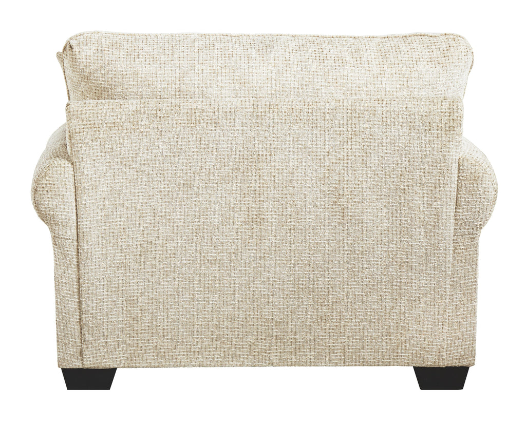 Sandstone upholstered chair back view with wide arms and dark block feet