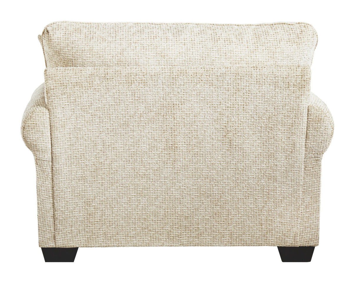 Sandstone upholstered chair back view with wide arms and dark block feet