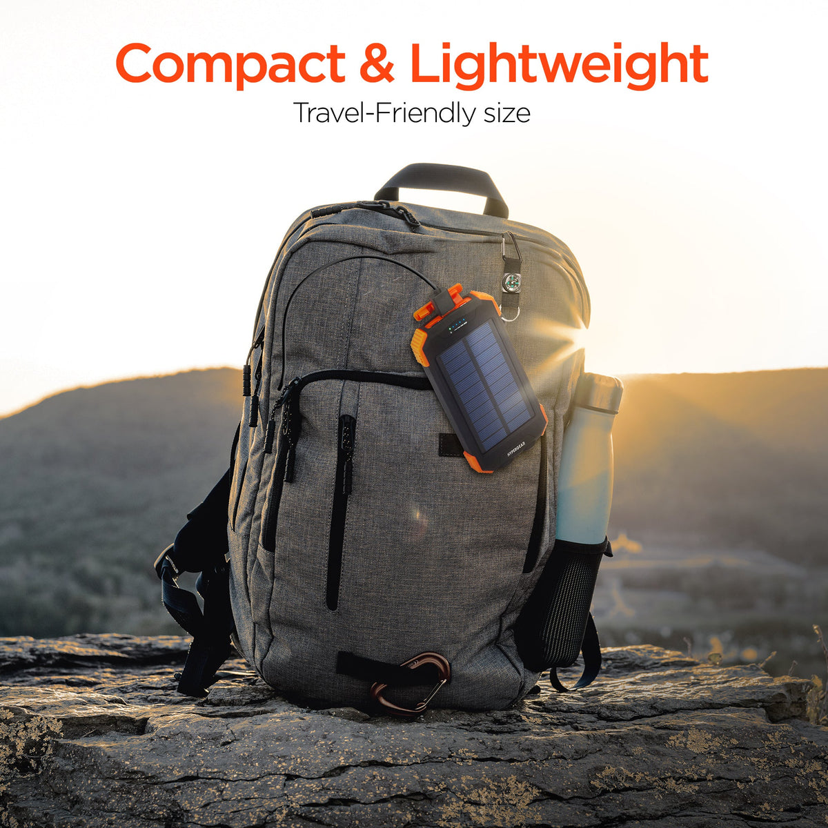 Compact gray travel backpack with attached black and orange solar power bank