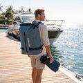 52L waterproof backpack in blue-gray with roll-top, side buckles, and shoulder straps