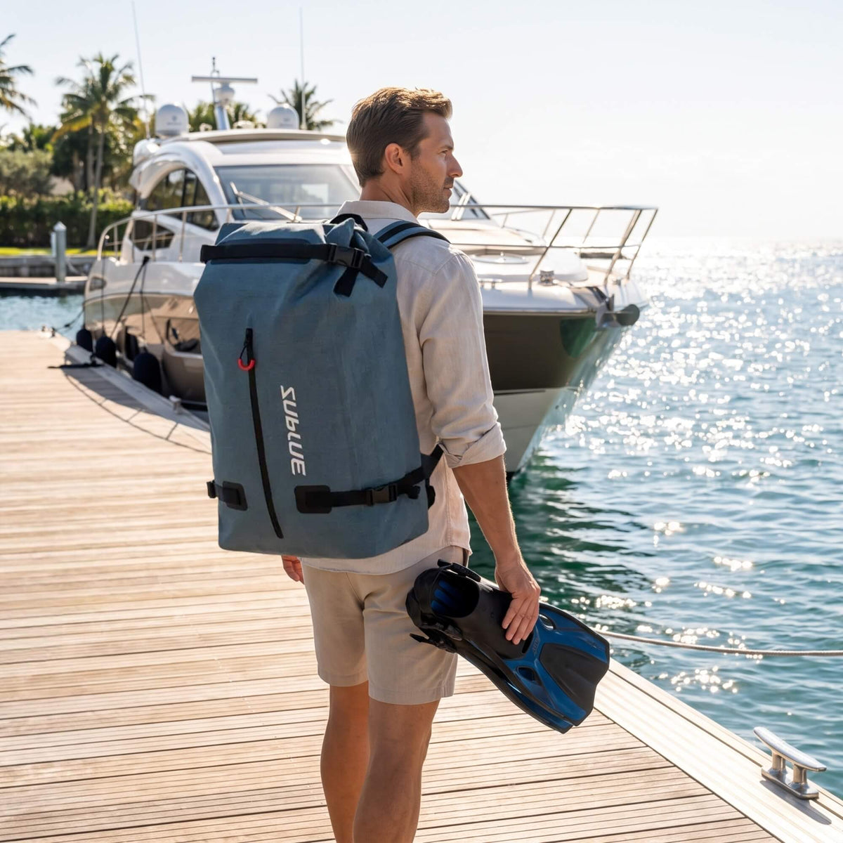 52L waterproof backpack in blue-gray with roll-top, side buckles, and shoulder straps