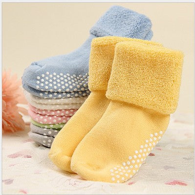 Yellow, light blue, and pink children non-slip socks with dotted grip soles